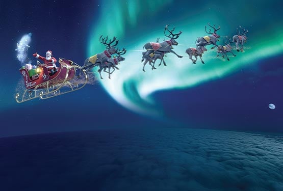 An illustration of Santa's sleigh, pulled by reindeer in the sky.