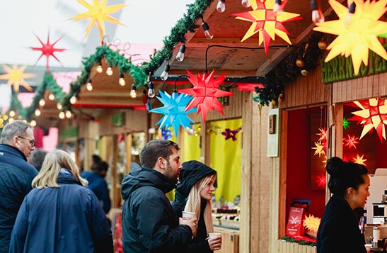 People shop at a Christmas market.