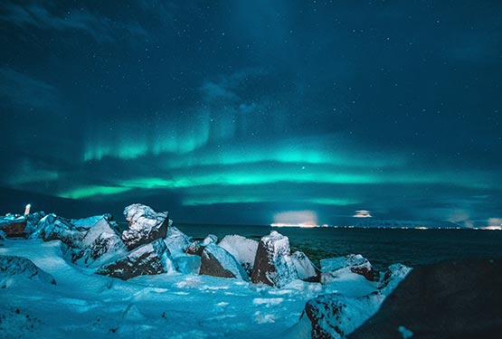 A teal aurora above an Icelandic ice shelf.